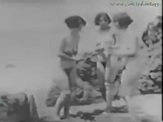 1928 vintage with a juvenile spying girls on the beach